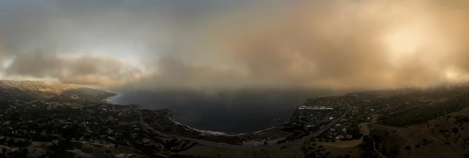 Breathtaking panoramic view of coastal cliffs under a misty sky Photos