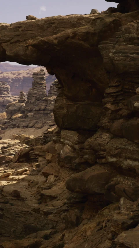 Breathtaking sandstone arch standing strong in a rugged desert landscape Stock Footage 335233572