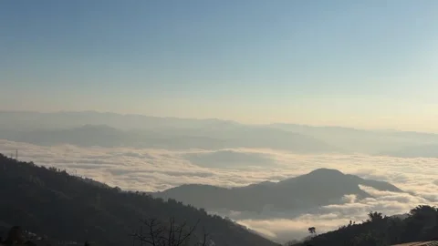 Breathtaking Sea of Clouds Over Mountain Range at Sunrise 動画素材 332382558