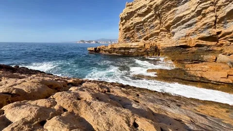 Breathtaking Serene Coastal View Featuring Majestic Rocky Cliffs and Gentle Stock Footage 309642531