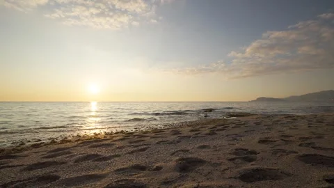 A breathtaking slow motion still shot capturing a tranquil beach during sunset Stock Footage 302795268