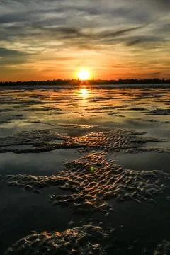 A breathtaking sunrise over the tidal mudflats of Roebuck Bay in Broome Stock Photos