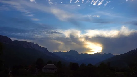 Breathtaking sunset behind the clouds with background of mountain peaks Video stock 118086050