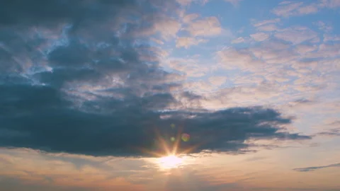 A breathtaking sunset with dramatic clouds and vibrant hues that enhance the atm Stock Footage 313465566