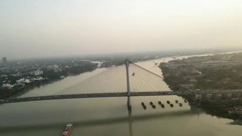 Breathtaking sunset drone view of Vidyasagar Bridge, silhouetted against the Stock Footage 299213176