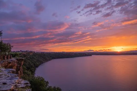 A breathtaking sunset at a lake with cliffs 写真素材