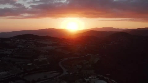 A breathtaking sunset over mountainous landscape with warm golden glow Stock Footage 309463758