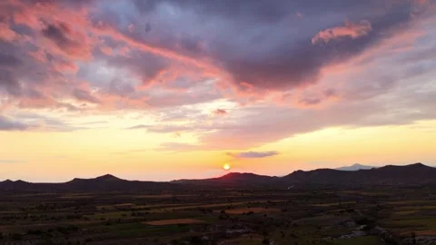 Breathtaking Sunset Over Mountains and Fields in a Serene Evening Sky Video stock 314057923