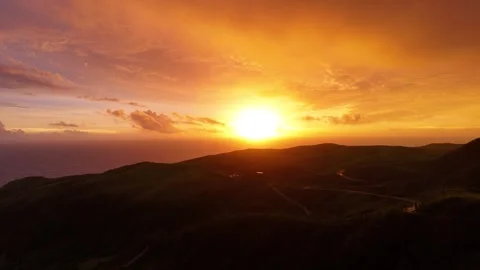Breathtaking Sunset Over Rolling Hills - Vibrant Orange and Green Landscape Stock Footage 304168985