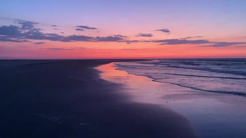 A breathtaking sunset paints the sky and ocean with vibrant colors Stock Footage 313957475