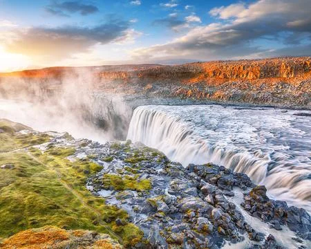 Breathtaking sunset view of the most powerful waterfall in Europe called De.. Stock Photos