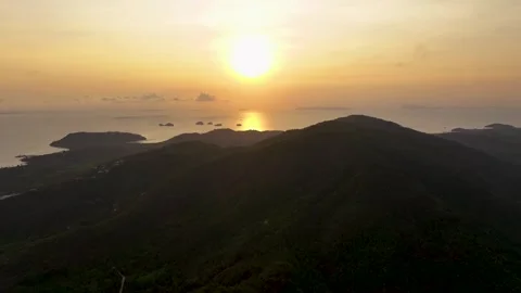 Breathtaking sunset view over the tranquil hills and ocean shoreline at dusk Stock Footage 308877897