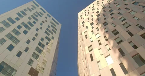 Breathtaking top-down perspective of two skyscrapers against a bright blue sky Stock Footage 294263111