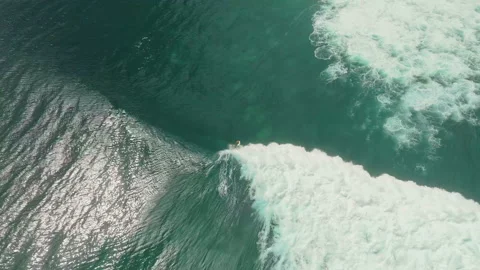 Breathtaking Top Down Shot Surfer Paddling Lineup Uluwatu 4K 库存影片 341410011
