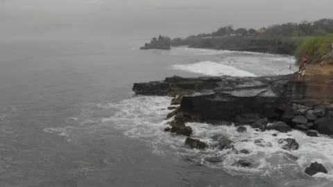 Breathtaking top view of big waves crashing into the black volcanic rocks cliff  Stock Footage 130839679