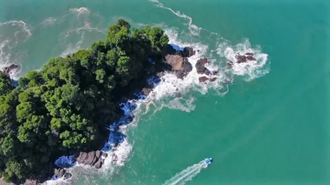 Breathtaking top view of excursion boat sailing around tropical paradise cove Stock Footage 154339775