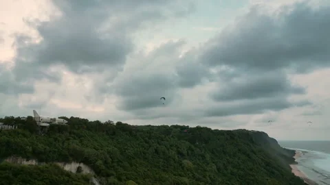 Breathtaking Uluwatu Ocean Cliffs and Paraglider Aerial View 4K Stock Footage 339300575