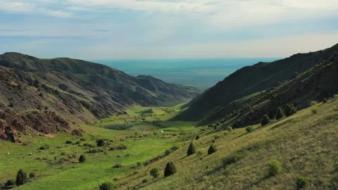 Breathtaking valley opening onto a vast blue lake Stock Footage 314423747