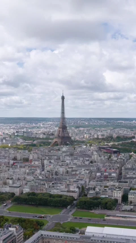 A breathtaking vertical aerial drone shot flying backwards from the Eiffel Stock Footage 328295317