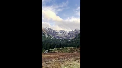 A breathtaking view of the alpine mountains with snow-capped peaks and rustic Stock Footage 288047668