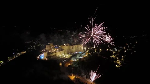 A breathtaking view of Castello do Rocca illuminated at night with fireworks lig Stock Footage 297062064