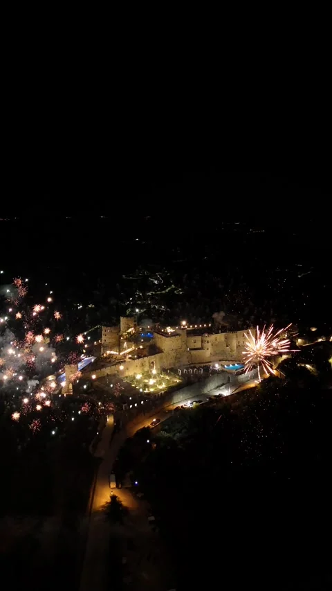 A breathtaking view of Castello do Rocca illuminated at night with firework.. Stock Footage 297062368