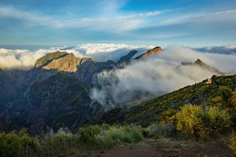 Breathtaking view of the cloudy mountains on the trail to Pico Ruivo in Madei Stock Photos