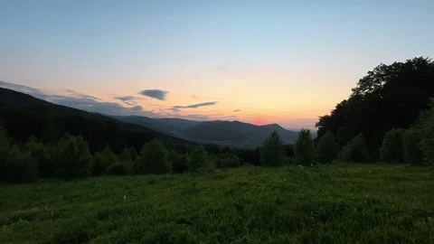 Breathtaking view of cloudy sundown sky over mountains in summer evening Stock Footage 333562463