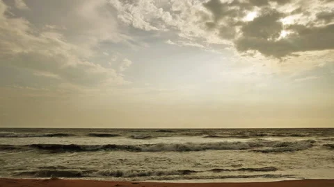 A breathtaking view of gentle ocean waves beneath a dramatic, cloud-filled sky. Stock Footage 293118613