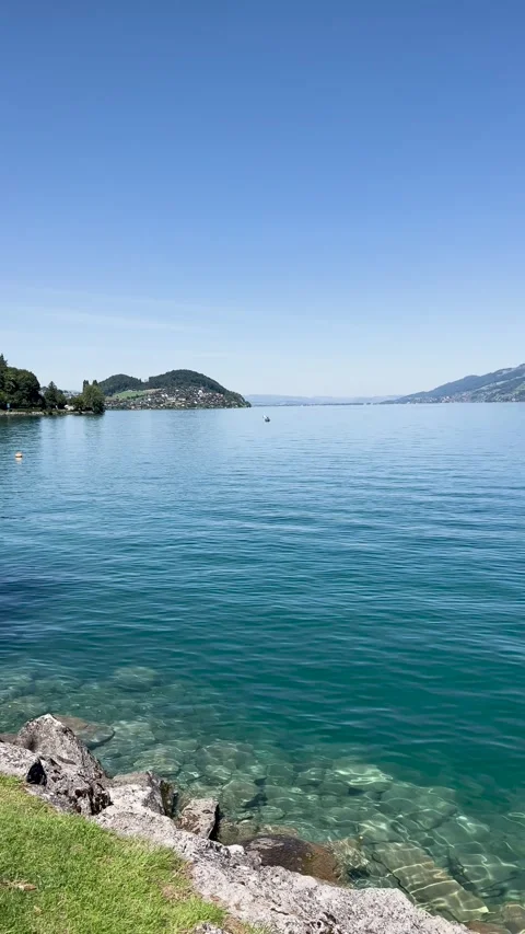 The breathtaking view of the lakeside under a clear and beautiful blue sky is Stock Footage 304783972