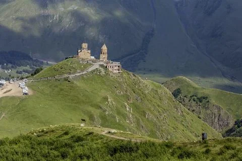 Breathtaking view of a mountain range with a ancient Gergeti Trinity Church.. Stock Photos