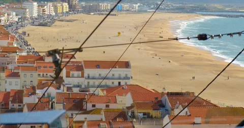 Breathtaking view from a moving cable car in Nazare sunny beach, Portugal Stock Footage 309654357