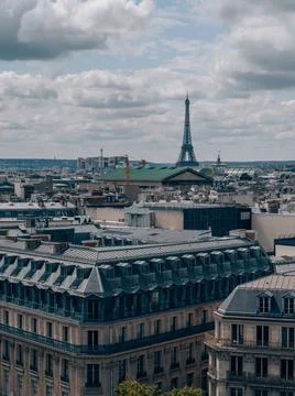 Breathtaking view of the Paris skyline with the Eiffel Tower under a cloudy s Stock Photos