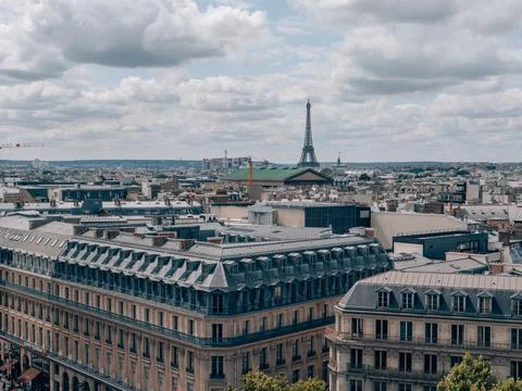 Breathtaking view of the Paris skyline with the Eiffel Tower under a cloudy s Stock Photos