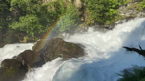 A breathtaking view of a powerful waterfall surrounded by lush greenery Stock Footage 313949442