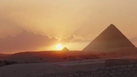 Breathtaking view of the pyramids at sunset, with the golden sun casting a .. Stock Footage 287021359