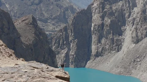 A breathtaking view of a remote glacial lake nestled in the mountains of Stock Footage 317958265