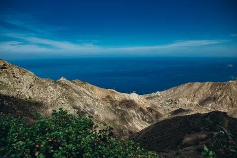A breathtaking view of rugged mountain landscape meeting the vast ocean und.. Stock Photos