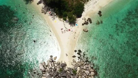 Breathtaking view of a secluded beach with crystal clear waters and rocky Stock Footage 319654019