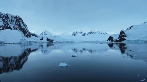 Breathtaking view of a snow-covered mountain range under a partly cloudy sky. Stock Footage 297844414