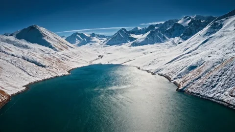Breathtaking view of a snow-covered mountain range under a partly cloudy sky. Stock Footage 297846422