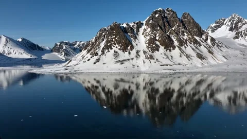 Breathtaking view of a snow-covered mountain range under a partly cloudy sky. Stock Footage 297848766