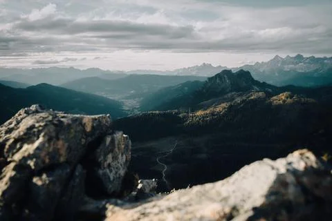 A breathtaking view of a stunning mountain range from a rocky cliff Stock Photos