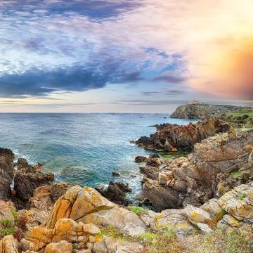 Breathtaking view of sunset  over old Capo Ferro Lighthouse. Stock Photos