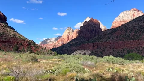 Breathtaking view of towering red rock mountains under bright blue sky changing Stock Footage 304734056