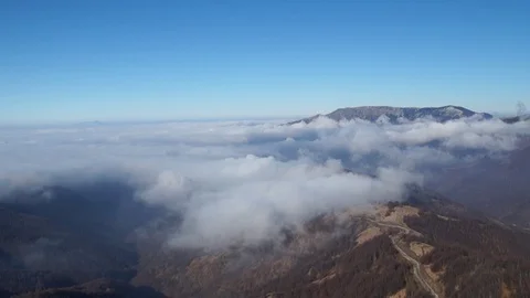 Breathtaking view of white clouds flowing against mountain tops Stock Footage 129008926