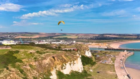Breathtaking views in this drone video of a paraglider soaring above Stock Footage 283344015