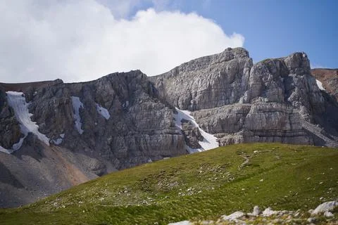 Breathtaking views of the mountain range surrounded by alpine meadows. Stock Photos