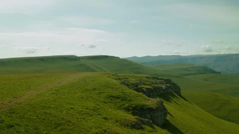 Breathtaking views of rolling hills and dramatic cliffs in a serene landscape Stock Footage 313106900