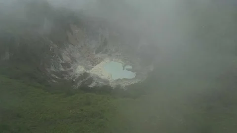 Breathtaking Volcanic Lake with Clouds Mount Mahawu Aerial Shot 動画素材 339875654